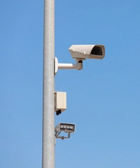 監控攝像頭安裝在立桿上，藍天背景下。